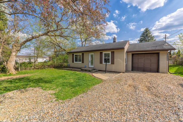 ranch-style house with a front yard, a chimney, gravel driveway, and an attached garage