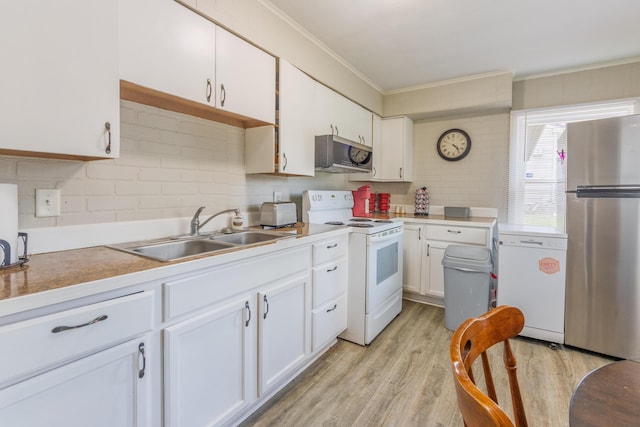 kitchen with a sink, tasteful backsplash, crown molding, white cabinetry, and appliances with stainless steel finishes