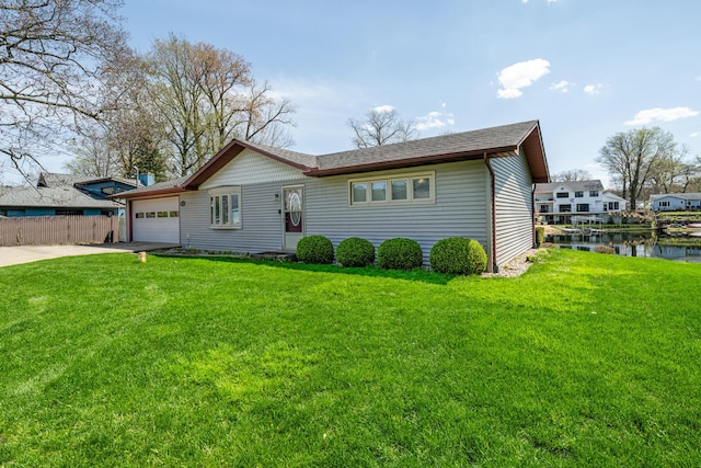 ranch-style house with fence, concrete driveway, a front lawn, and a garage