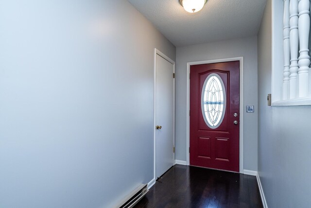 entryway with dark wood-style floors, baseboards, and a textured ceiling