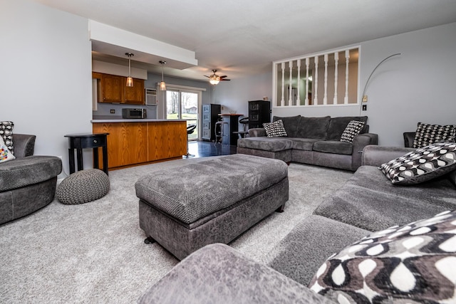 living area featuring a ceiling fan