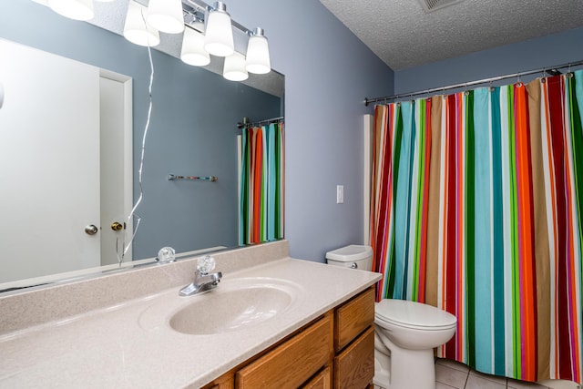 full bath featuring tile patterned floors, a textured ceiling, vanity, and toilet