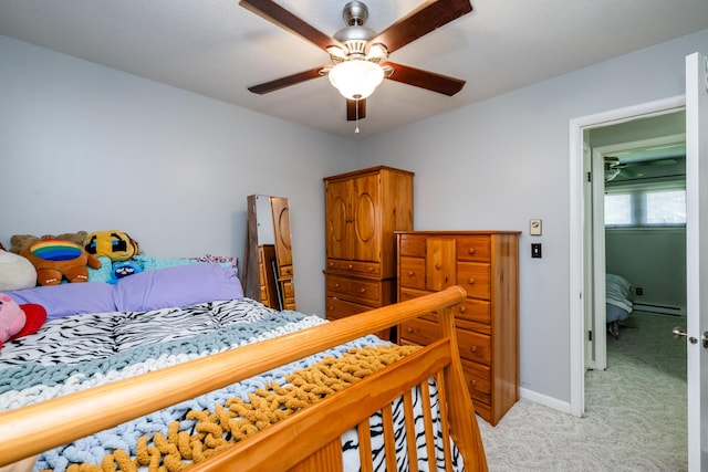 bedroom featuring baseboard heating, baseboards, ceiling fan, and light colored carpet
