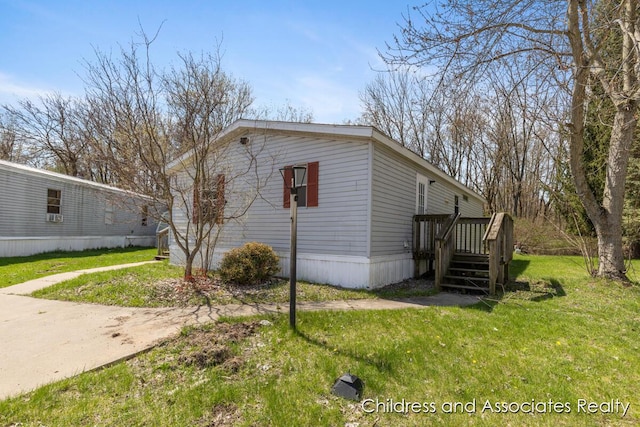 view of side of property featuring a wooden deck and a yard