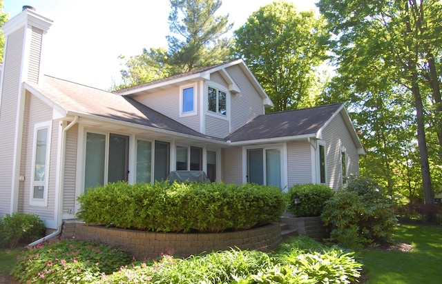 417 Francis St, Saugatuck, MI 49453 - view of side of home featuring a chimney