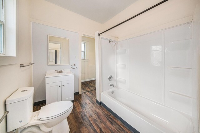 bathroom with bathtub / shower combination, wood finished floors, toilet, and vanity