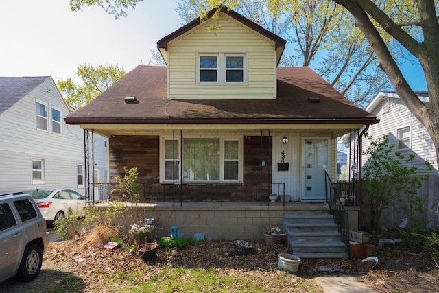 bungalow-style home with a porch and a shingled roof