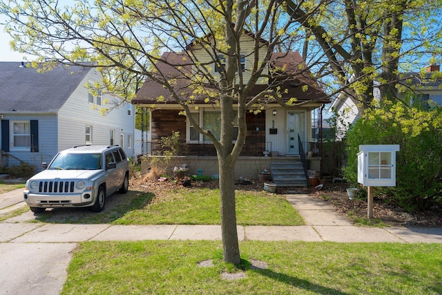 bungalow-style home with a porch and a front yard
