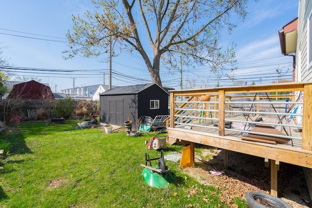 view of yard with a deck, a shed, and an outbuilding
