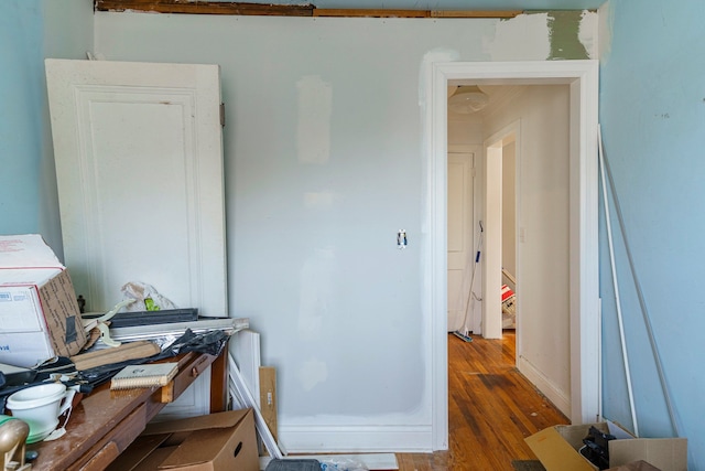 interior space featuring baseboards and wood finished floors