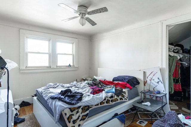 bedroom with a ceiling fan, a closet, and wood finished floors