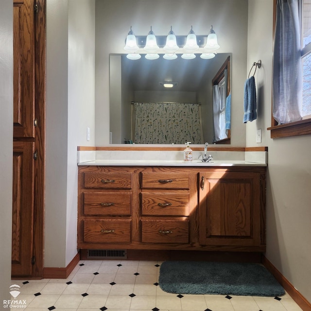full bath featuring baseboards, visible vents, and vanity