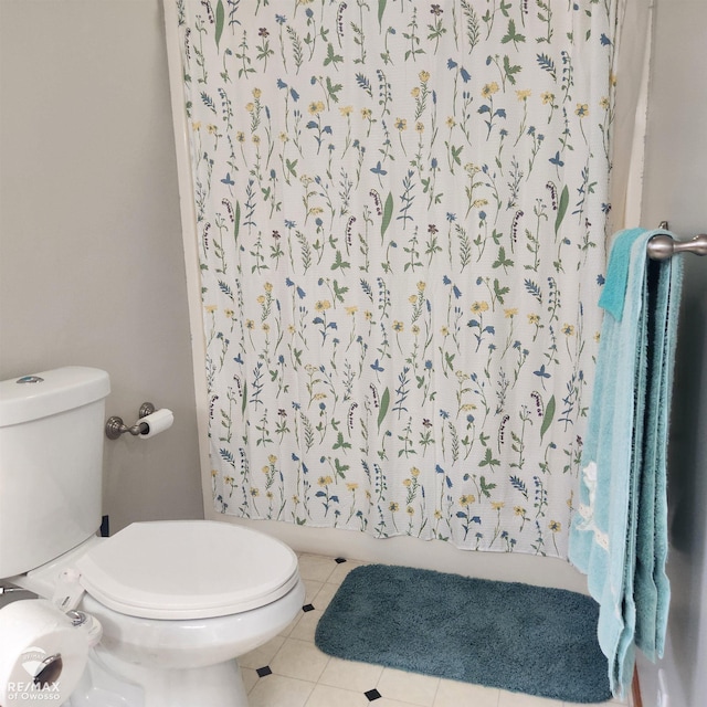 bathroom with toilet and tile patterned floors