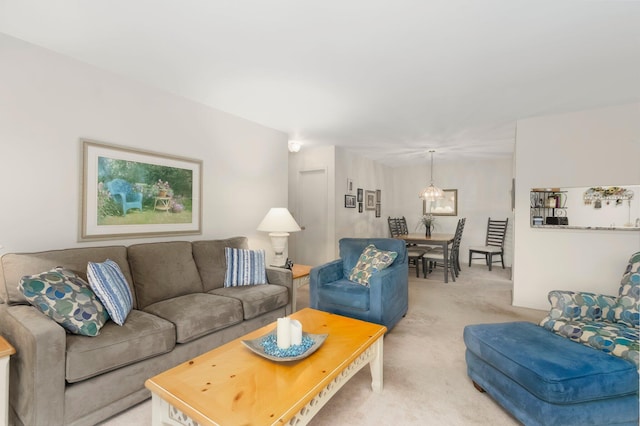 living area with a chandelier and light colored carpet