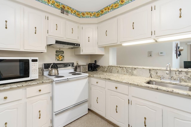 kitchen with a sink, under cabinet range hood, light stone counters, white appliances, and white cabinets