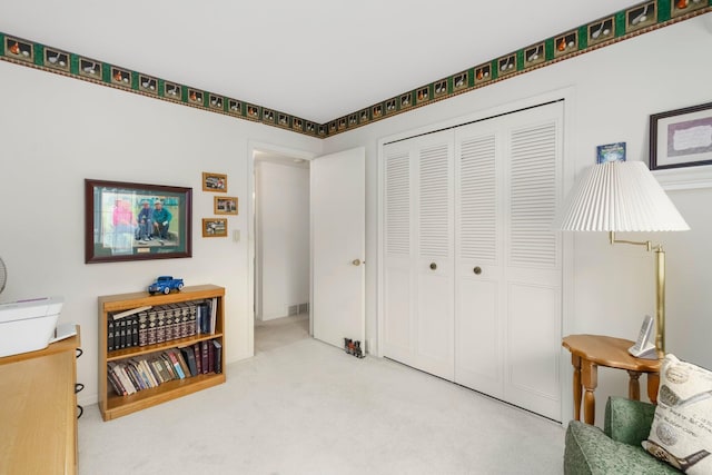 sitting room featuring visible vents and carpet floors