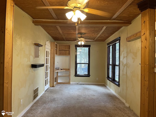 empty room with baseboards, visible vents, a ceiling fan, and carpet floors