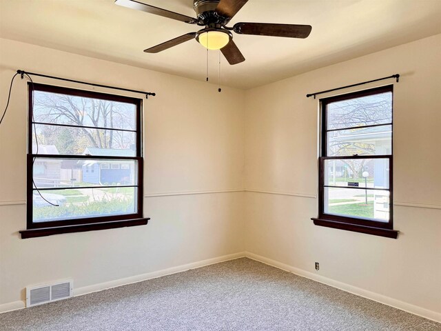 2408 N Mason St, Saginaw, MI 48602 - carpeted empty room with plenty of natural light, baseboards, and ceiling fan