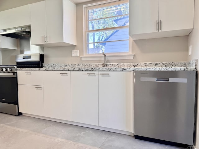 2408 N Mason St, Saginaw, MI 48602 - kitchen featuring appliances with stainless steel finishes, extractor fan, light stone countertops, and white cabinetry