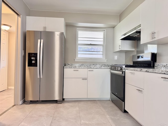 2408 N Mason St, Saginaw, MI 48602 - kitchen with stainless steel appliances, under cabinet range hood, light stone counters, and white cabinetry