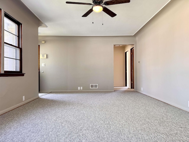 2408 N Mason St, Saginaw, MI 48602 - spare room featuring a ceiling fan, light carpet, and baseboards