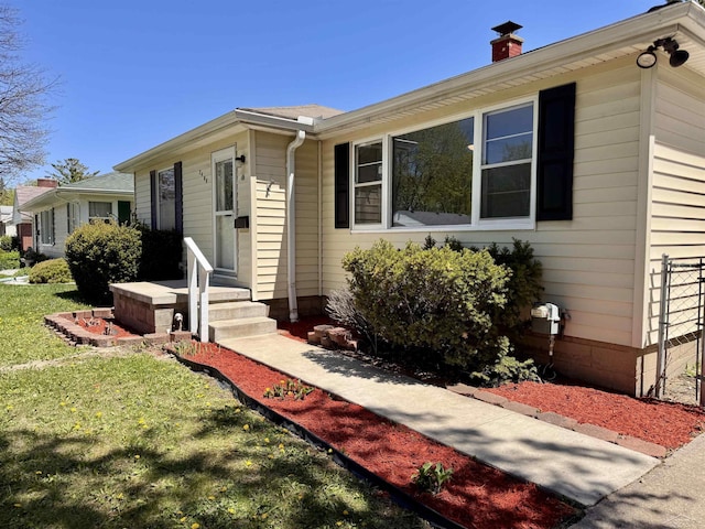 2408 N Mason St, Saginaw, MI 48602 - single story home with a chimney and a front lawn