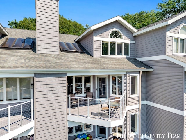 810 S Harbor Dr Unit 21, Grand Haven, MI 49417 - rear view of house with a chimney and a shingled roof