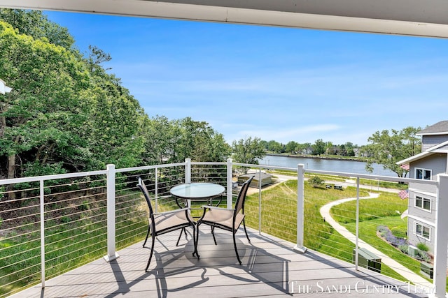 810 S Harbor Dr Unit 21, Grand Haven, MI 49417 - balcony with a water view and view of wooded area