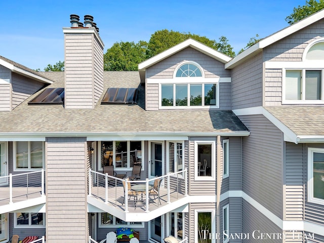 810 S Harbor Dr Unit 21, Grand Haven, MI 49417 - rear view of property with a chimney and roof with shingles