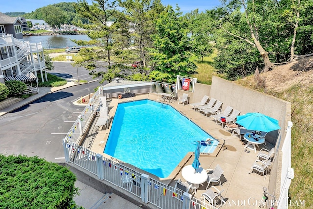 810 S Harbor Dr Unit 21, Grand Haven, MI 49417 - community pool with a water view, a patio, and view of scattered trees