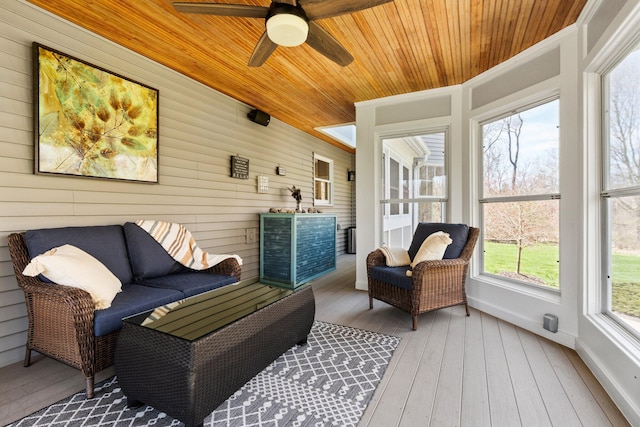 sunroom featuring ceiling fan and outdoor lounge area