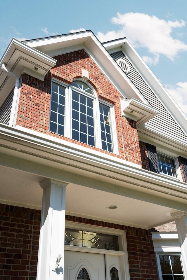 view of property exterior with brick siding
