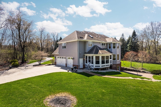 back of house with driveway, a lawn, a sunroom, and a garage