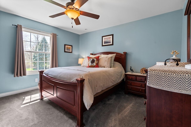 bedroom with dark colored carpet, ceiling fan, and baseboards