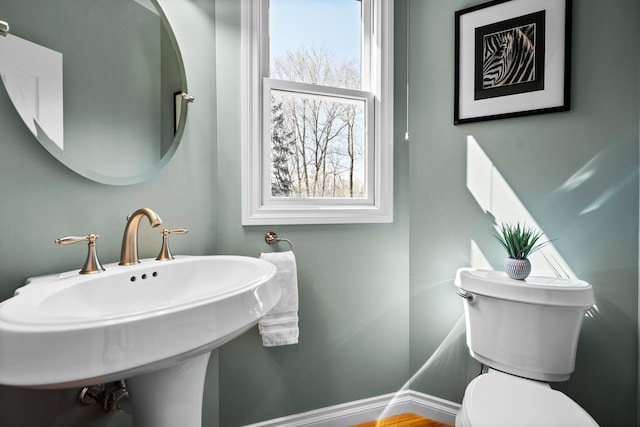 half bathroom with toilet and a sink
