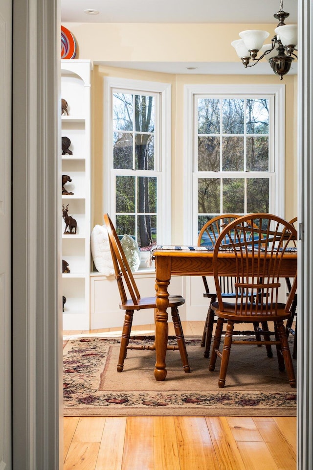 dining space featuring an inviting chandelier and wood finished floors