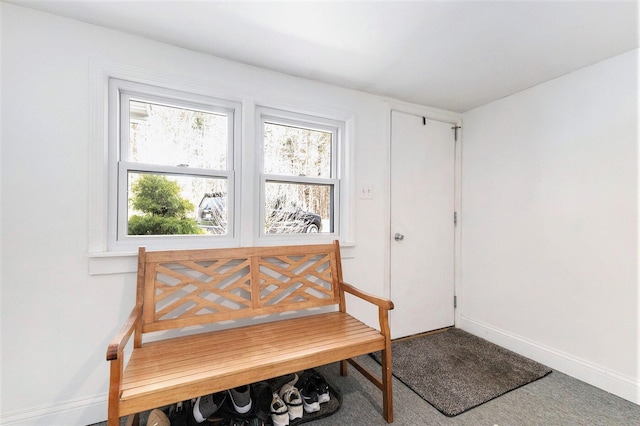 doorway to outside featuring a wealth of natural light, carpet flooring, and baseboards
