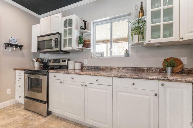 kitchen featuring glass insert cabinets, white cabinets, stainless steel appliances, and baseboards