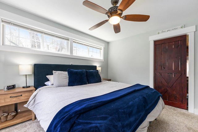 bedroom with a ceiling fan and carpet floors