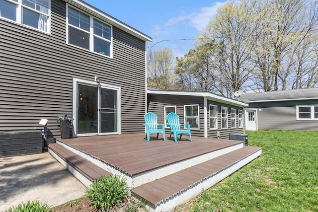 deck with central AC unit and a lawn