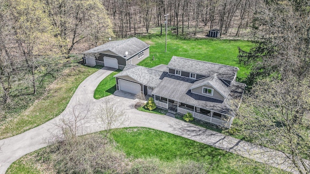 bird's eye view with a wooded view