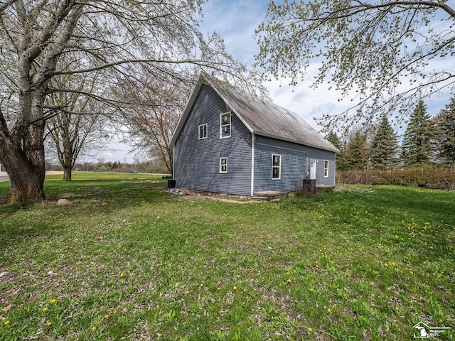 view of property exterior featuring a lawn