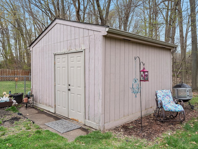 view of shed featuring fence