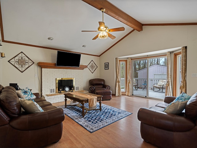living area featuring a brick fireplace, wood finished floors, beamed ceiling, ceiling fan, and high vaulted ceiling