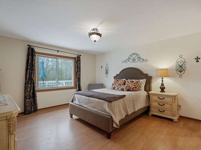 bedroom featuring baseboards and light wood-style flooring