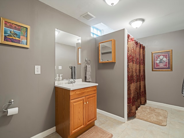 full bathroom with baseboards, visible vents, and vanity