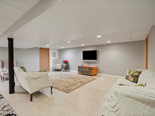 living area with recessed lighting, a paneled ceiling, and baseboards