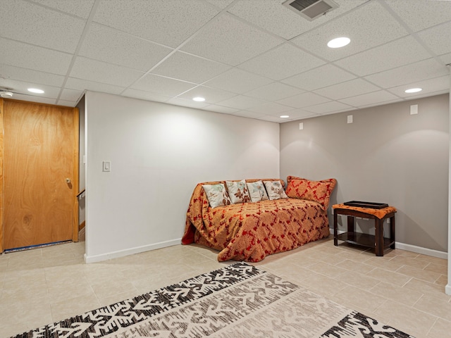 bedroom featuring visible vents, baseboards, and a paneled ceiling