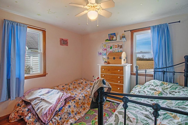 bedroom featuring ceiling fan and multiple windows