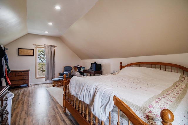 bedroom with baseboards, recessed lighting, wood finished floors, and vaulted ceiling